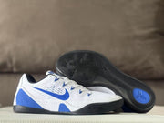 Nike Kobe 9 sneaker pair showing the black outsole tread and blue circular traction detail.