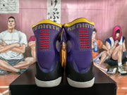 Rear view showing the purple high collars, red-and-gold heel detailing, black heel sections, and white outsoles.