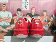 Rear view showing GT lettering on the heels of the red basketball shoes.