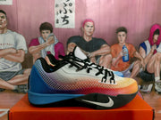 Side view of the mismatched Nike basketball sneakers, showing the blue shoe and the red, orange, and yellow shoe.