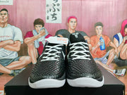 Front view of black and white Nike Kobe basketball shoes with textured uppers and white laces.