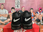 Rear view of black Nike high-top sneakers with white swoosh details, displayed on a Nike shoebox.