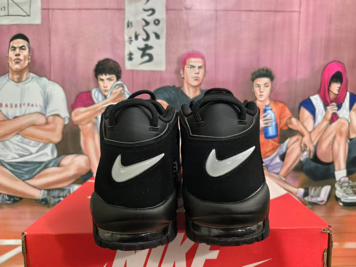 Rear view of black Nike high-top sneakers with white swoosh details, displayed on a Nike shoebox.