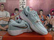 Angled view of two blue Nike sneakers displaying the black Swoosh, padded collars, perforated toe areas, and white midsoles.