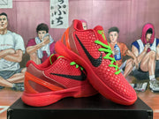 Angled display of the red Nike basketball sneakers showing the black Swoosh, green accents, textured uppers, and layered soles.