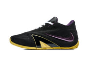 Side view of a black low-top basketball shoe with a purple Swoosh and gold-colored outsole.
