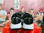 Rear view of black and white basketball shoes with red accents