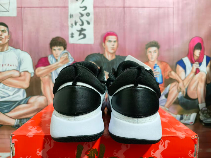 Rear view of black and white basketball shoes with red accents