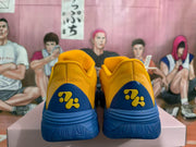 Rear view showing blue heel panels and sculpted soles