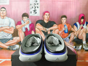 Rear view of gray slip-on shoes showing black and blue heel trim and Adidas marks.