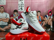 Angled view of the white and red Nike basketball shoes showing the side Swoosh and textured outsole.