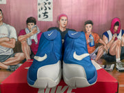 Front view of blue and white Nike The Glove sneakers showing covered uppers, white Nike logos, and white toe and outsole sections.
