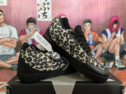 Angled view of the leopard-print sneakers displayed together, showing the black toe panels and side branding.