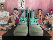 Front view showing turquoise laces and gray patterned uppers