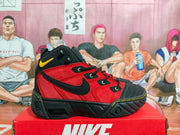 Side profile of a red and black Nike high-top sneaker with a black Swoosh-style side mark and chunky outsole.