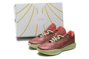 Pair of orange-red low-top sneakers with green soles and a matching patterned box.
