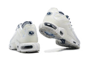 Rear views of white sneakers showing the heel and outsole