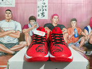 Front view of the red basketball sneakers showing black laces, textured toe boxes, and red outsoles.