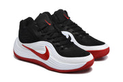 Three-quarter view showing the black upper, white side panels and red accents