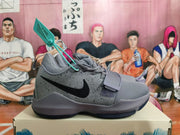 Side view of a gray Nike basketball shoe with a black Swoosh and speckled panel