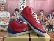 Angled view of two red and blue low-top sneakers displayed on a shoe box.