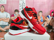 Angled view of red basketball sneakers showing black laces, patterned side panels, white side branding, and white midsoles.