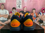 Rear view showing textured navy heel sections and orange heel panels.