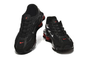 Pair of black Nike Shox Ride 2 sneakers with red details and silver Swooshes.