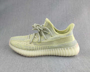 Side profile highlighting the pale green knit upper and translucent ribbed outsole.