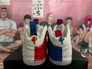 Rear view of the pair showing contrasting red and blue heel panels and embroidered tongue logos.