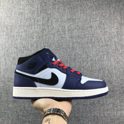 Side profile of a white, black and deep purple mid-top Jordan sneaker with red laces.