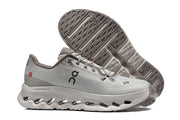 Side view of gray On Cloudmonster 3 shoes with outsole tread visible