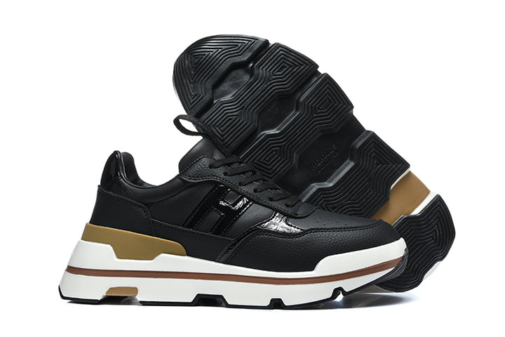 Black lace-up sneaker shown from the side with its patterned outsole raised behind it.