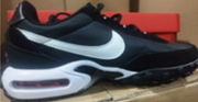 Side view of a black Nike sneaker with a white Swoosh and visible cushioning window.
