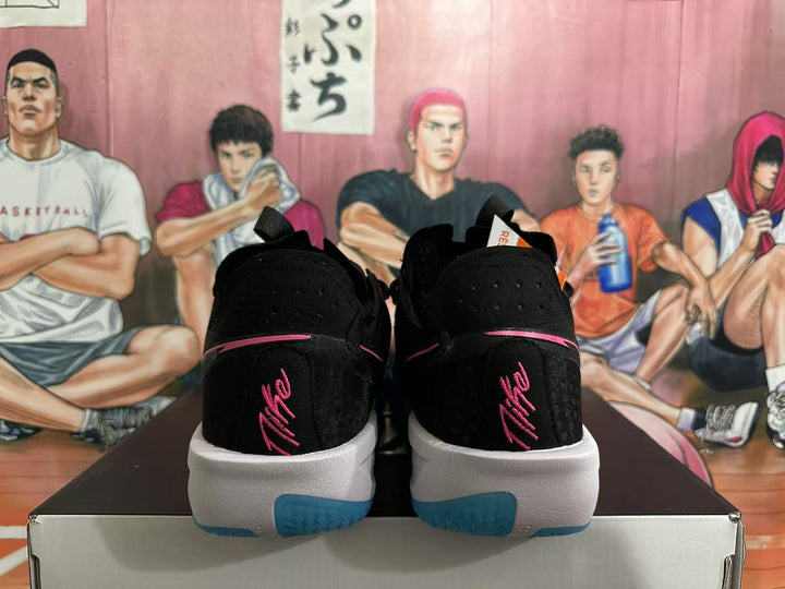 Rear view of black Nike GT Cut 3 shoes with pink details and blue outsole accents