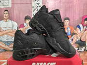 Angled view of paired black Nike sneakers highlighting the side panels, lace-up construction, and outsole detailing.