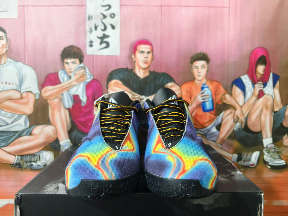 Front view of blue and purple Nike basketball shoes with orange accents and black laces