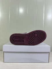 Close view of the burgundy rubber outsole with circular traction grooves.