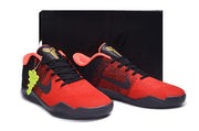 Red and black basketball shoes displayed in front of a black box