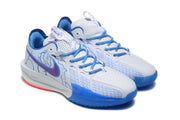 Pair of white and blue sneakers shown from an angled front view with blue laces and perforated uppers.