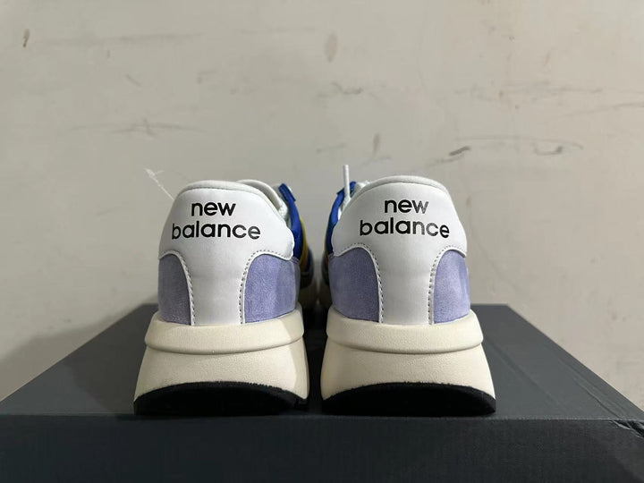 Rear view of New Balance U370 sneakers showing white heel panels and gray accents