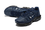 Pair of navy Nike Air Max Plus sneakers shown at an angled front view.