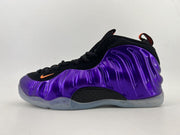 Black and purple high-top sneaker with a glossy molded side panel and translucent outsole.