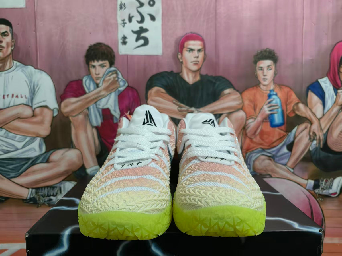 Front view of pink and white Nike basketball shoes with bright green outsoles