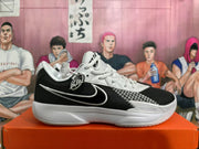Side view showing the Swoosh and patterned panel on a black and white Nike shoe