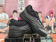 Angled view of the pair of black and gray Adidas sneakers showing the outsole tread, side panels, and lace-up design.