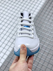 Front view showing white laces, tongue, glossy toe, and blue outsole edge.