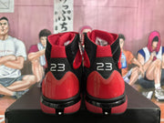 Rear view of black and red high-top sneakers showing the red heel panels, black midsoles, and number 23 details.