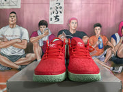 Front view of red Nike basketball shoes with red laces and mint-green outsoles.