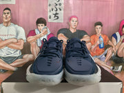 Front view of the navy and white basketball sneakers showing the lace-up design, padded tongues and translucent toe outsoles.